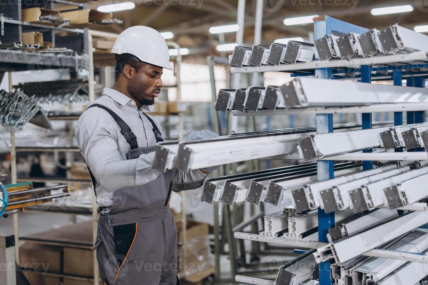 Factory worker checking aluminum window frames in production line photo