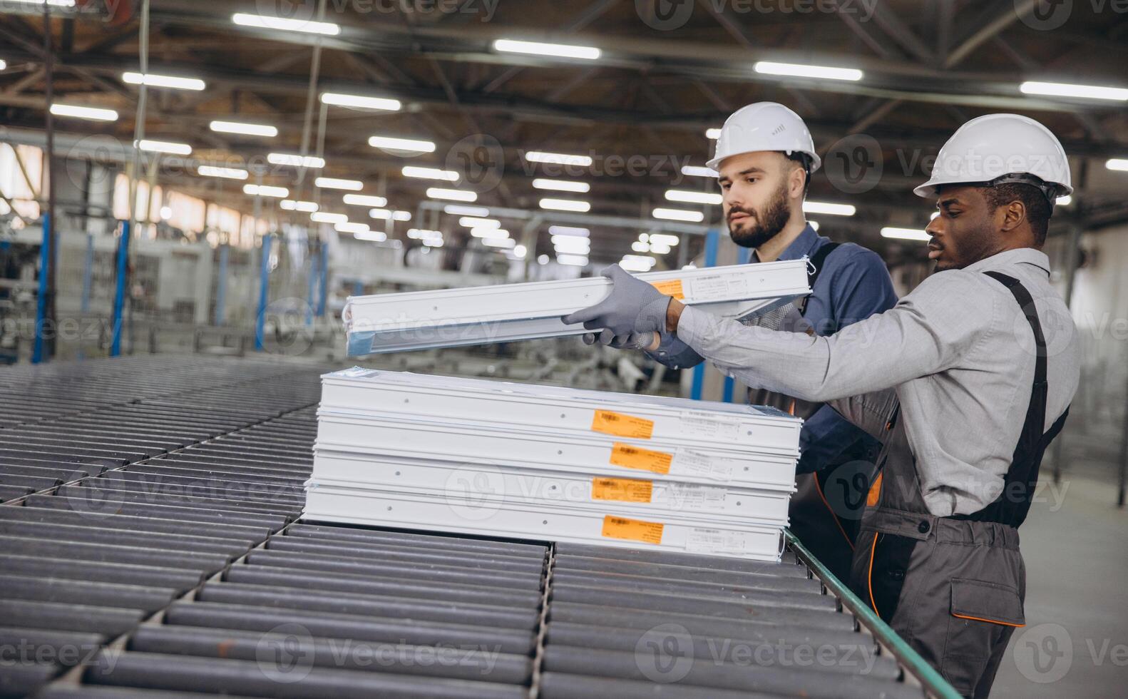 Factory workers assembling aluminum and pvc window frames on production line photo