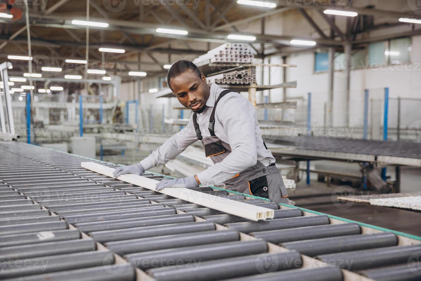 Factory worker handling pvc window frame on production line photo