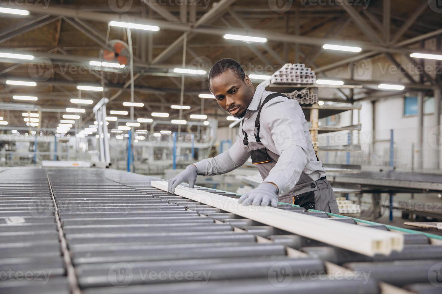 Factory worker checking pvc window frame on production line photo