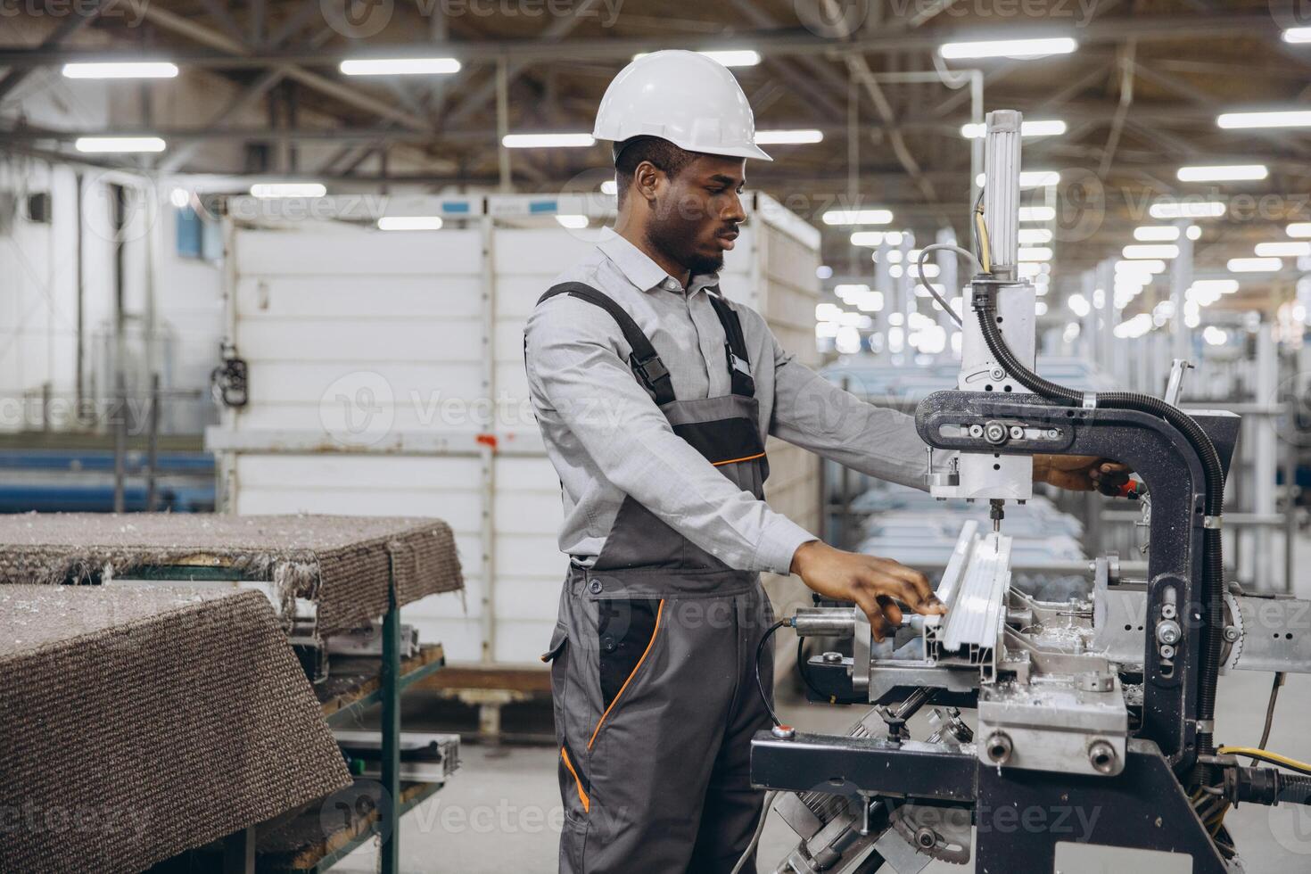 Factory worker operating machinery producing aluminum and pvc windows and doors photo