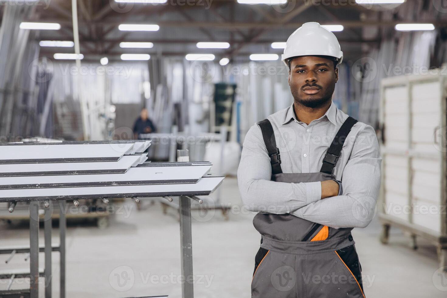 Supervisor posing with arms crossed in PVC windows and doors factory photo