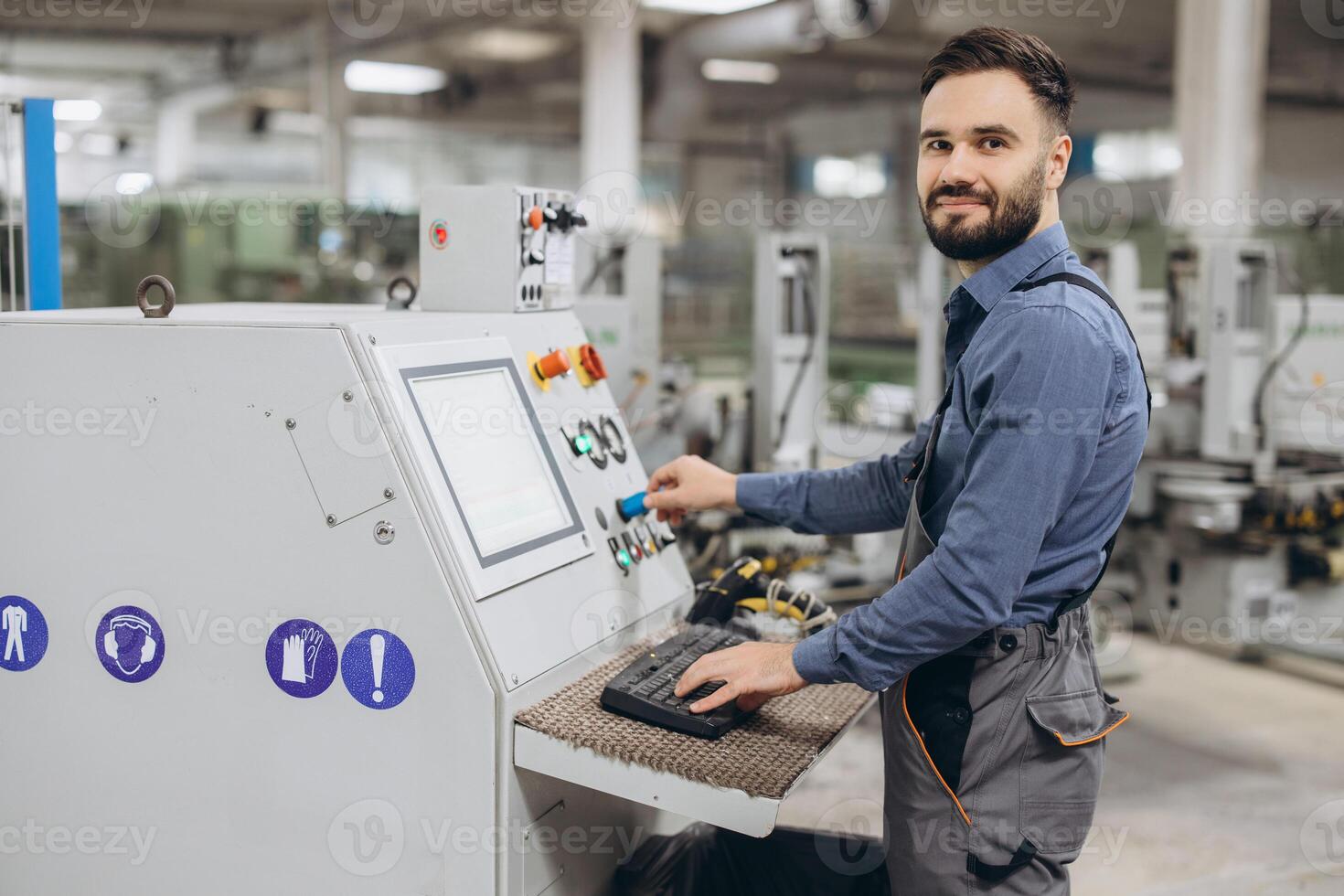 Factory worker operating industrial machinery for aluminum and pvc windows and doors production photo