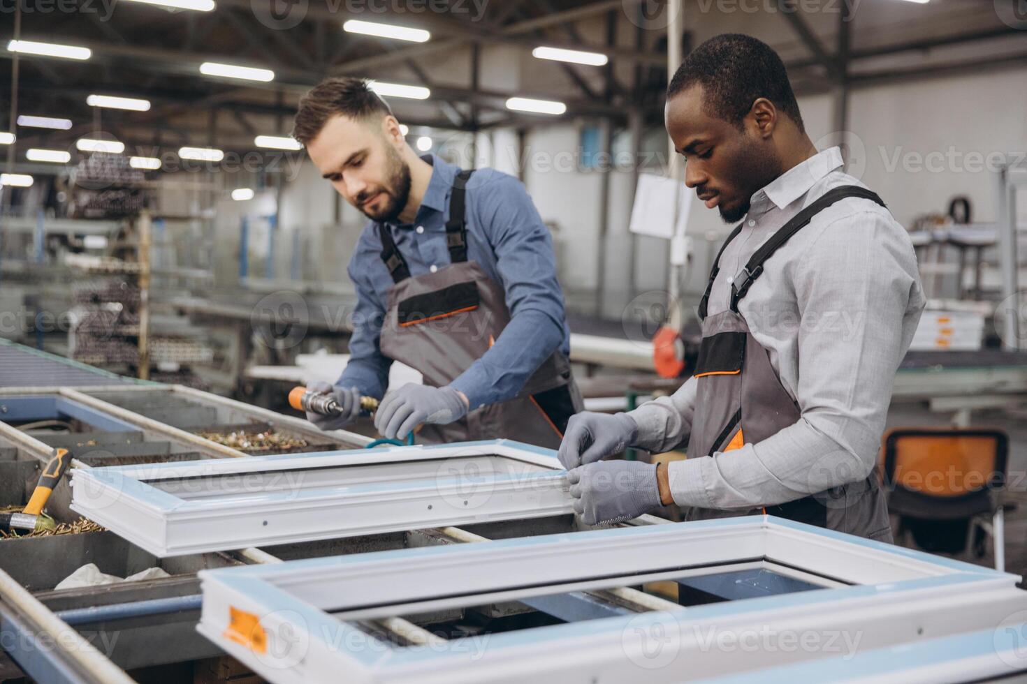 Factory workers assembling pvc windows in production line photo