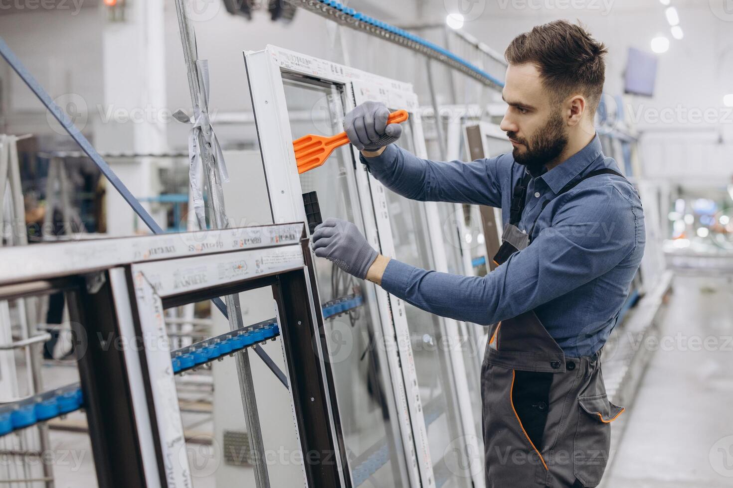Factory worker assembling aluminum and pvc window frame photo