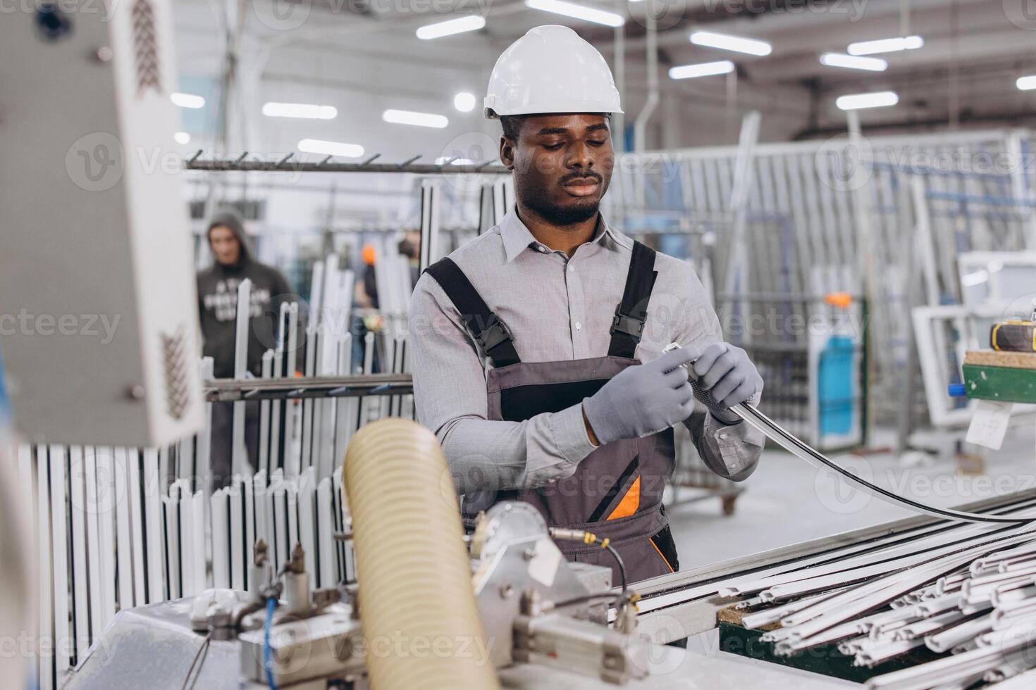 Factory worker assembling aluminum window frames in production line photo