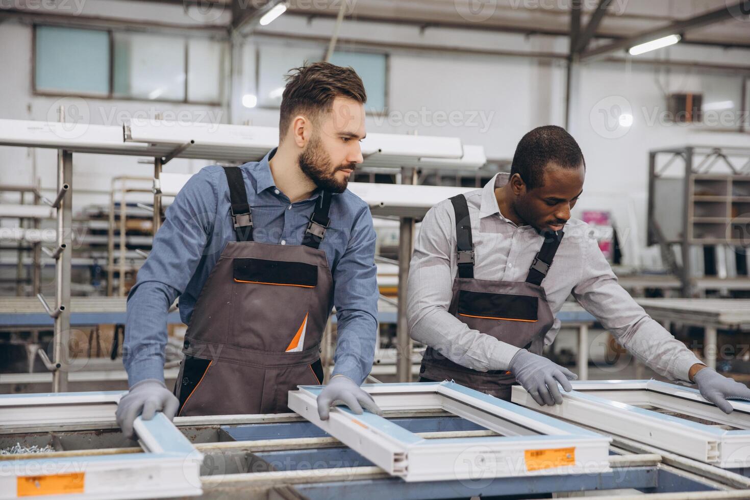 Factory workers assembling pvc windows in production line photo