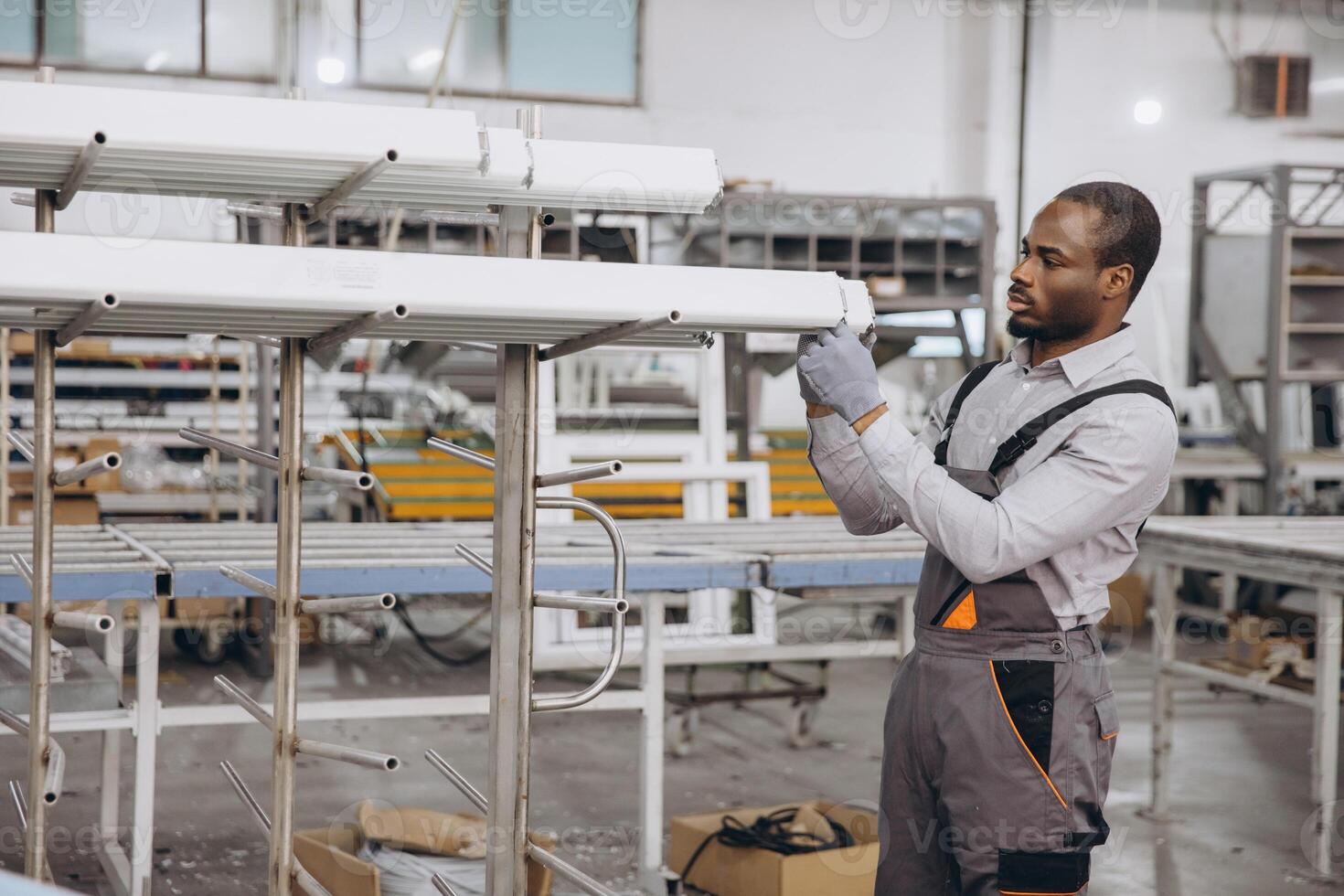 Factory worker preparing pvc window and door frames photo