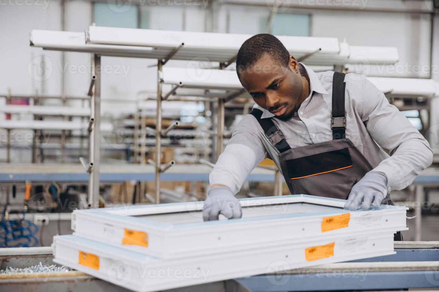 Factory worker assembling pvc windows in production line photo