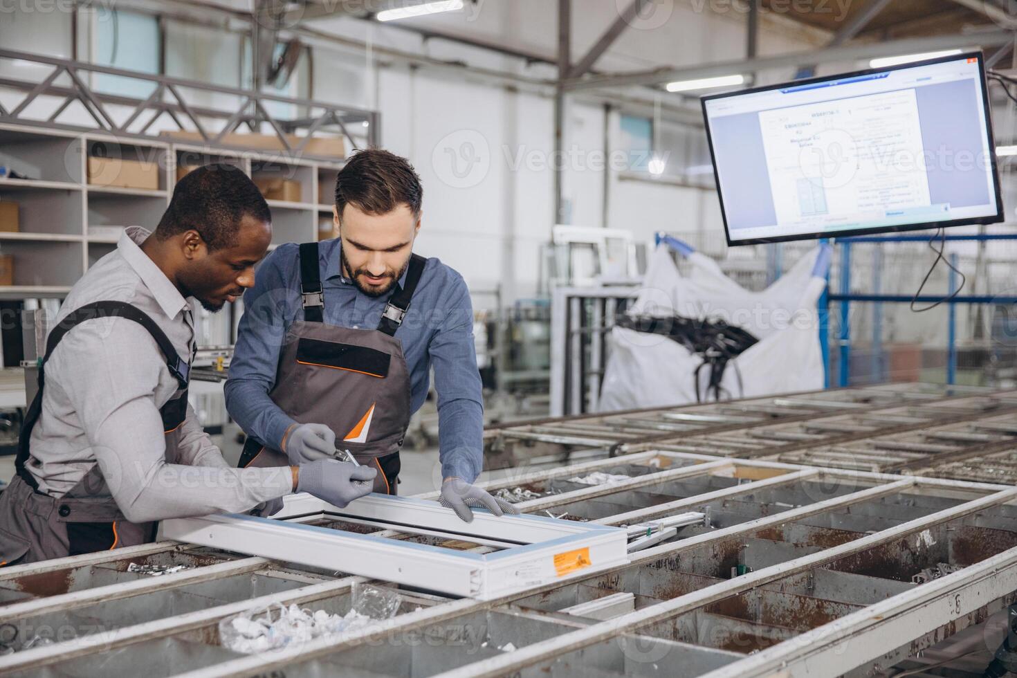 Factory workers assembling aluminum window frame in production line photo