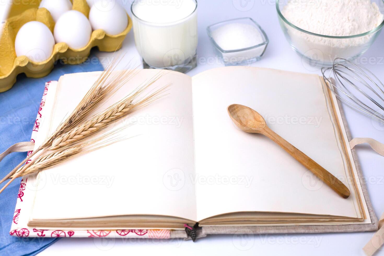 Empty recipe book and baking ingredients on the table. Cooking process. Close-up. photo