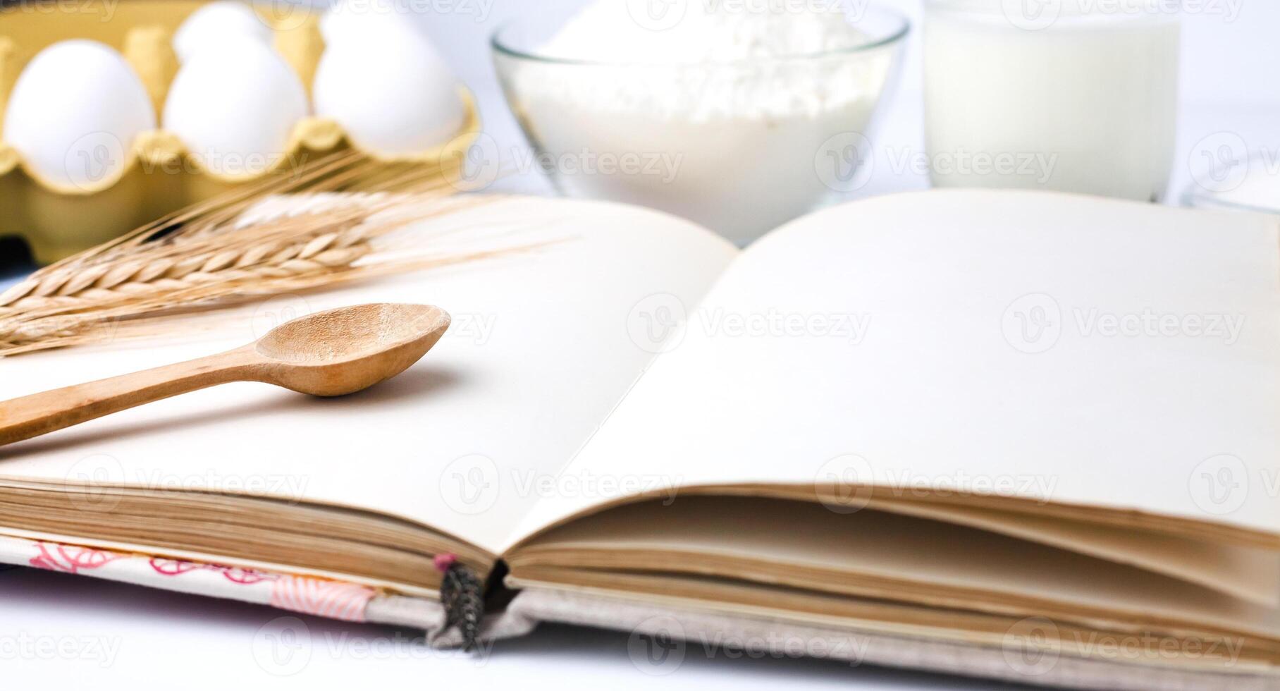 Recipe book on the kitchen table. Cooking process. Close-up. photo