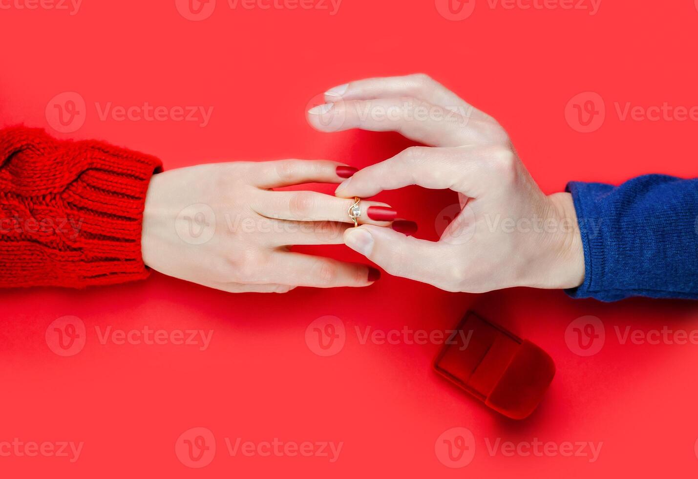 Man puts a ring on a girl's finger. Marriage proposal. Close-up. Top view. photo