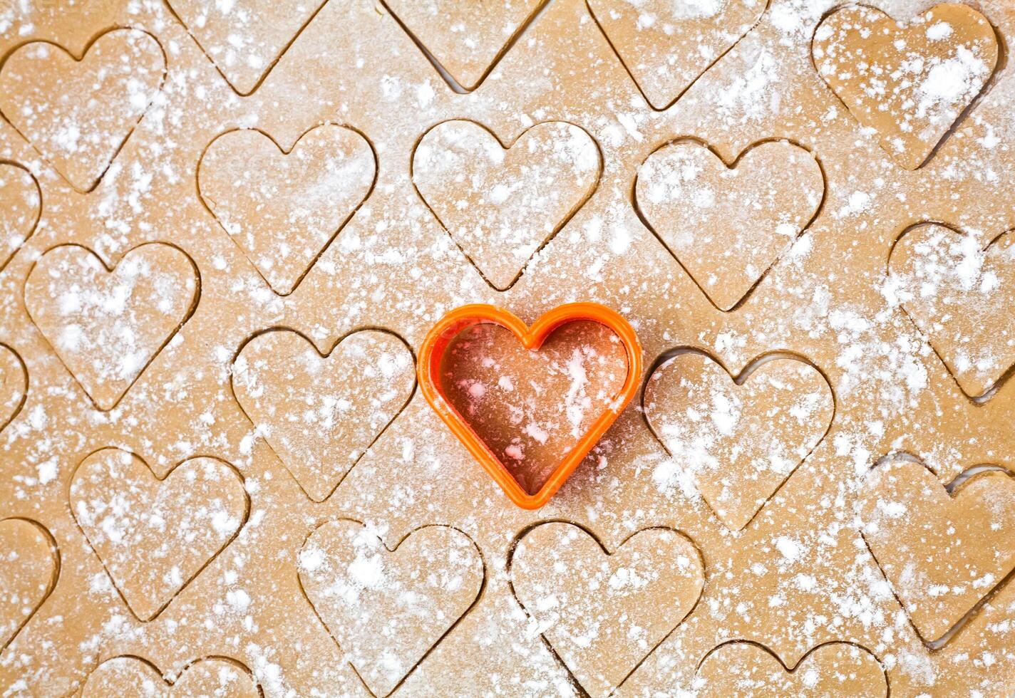Cooking process. Homemade cookies in the shape of a heart. Homemade pastry. Close-up. Top view. photo