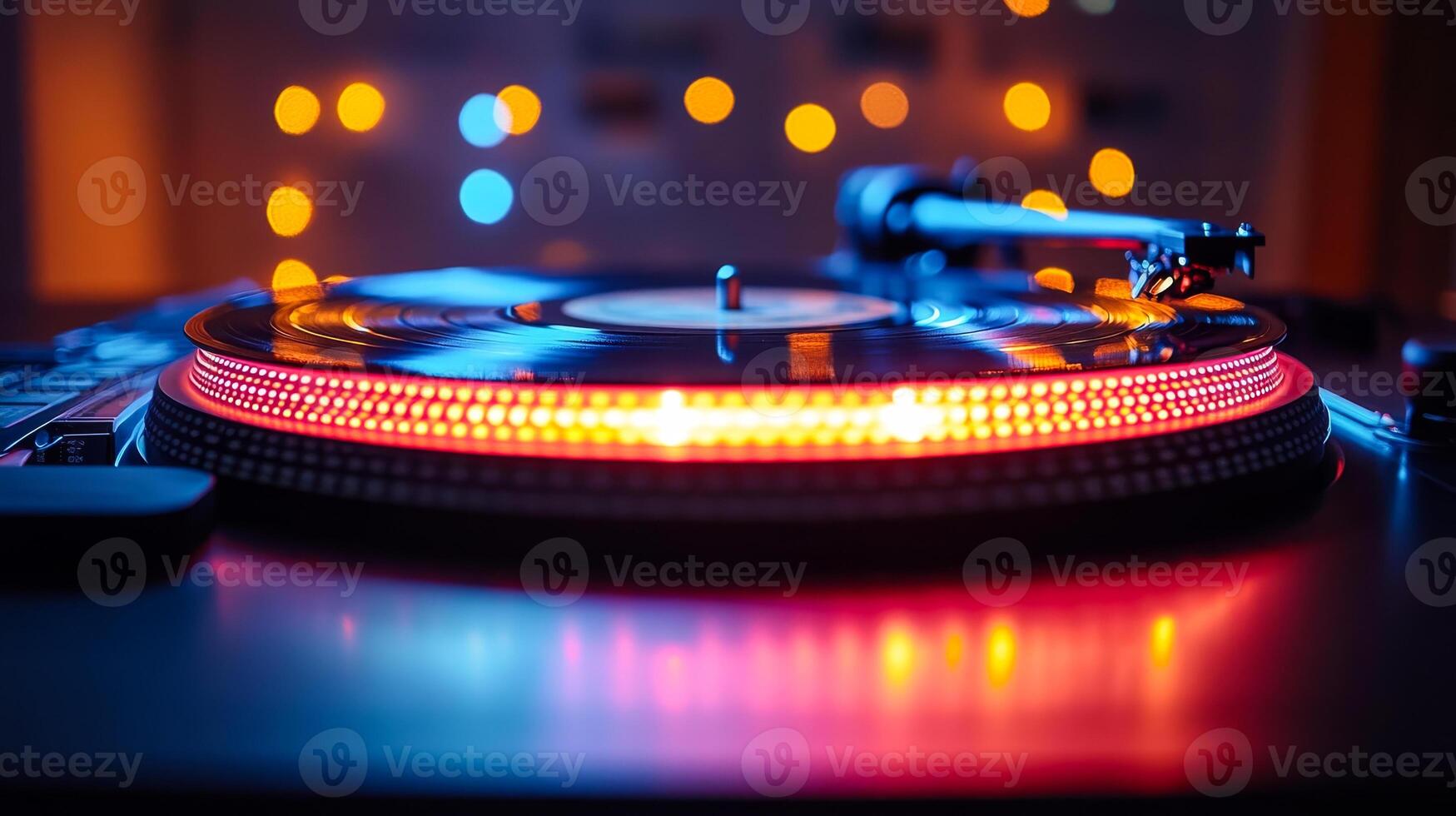 A record player with a red and yellow rim. The light on the record player is on and the record is spinning photo