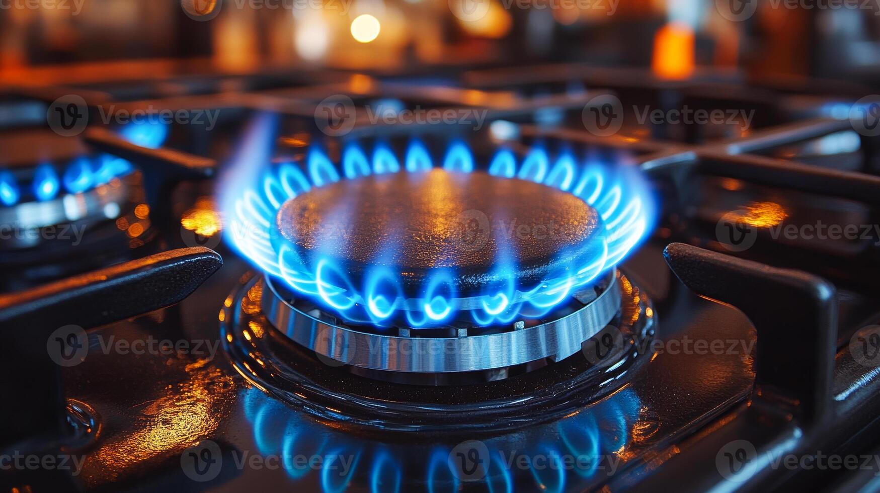 The stove burner is glowing with a blue and yellow flame. The stove is turned on, and the flame is still burning brightly photo