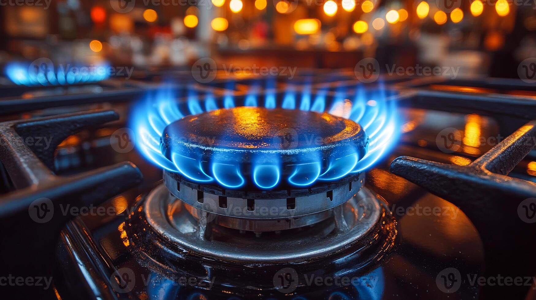 A gas stove burner is lit and the flame is blue. The stove is on a black surface photo
