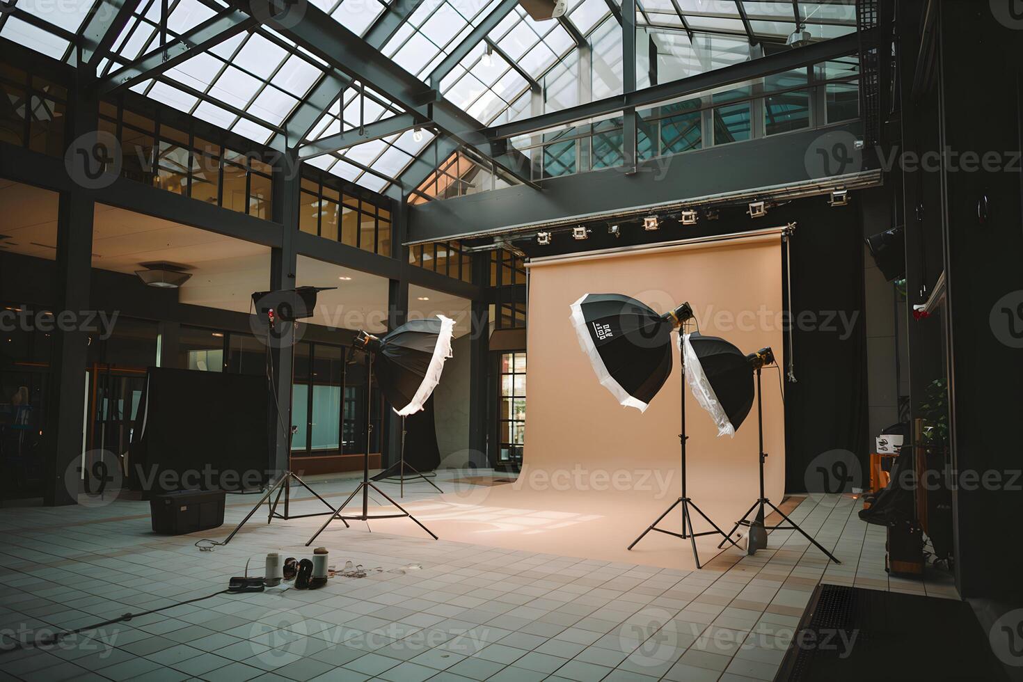 Photography studio with umbrella lighting, high ceilings, beige backdrop well lit photo