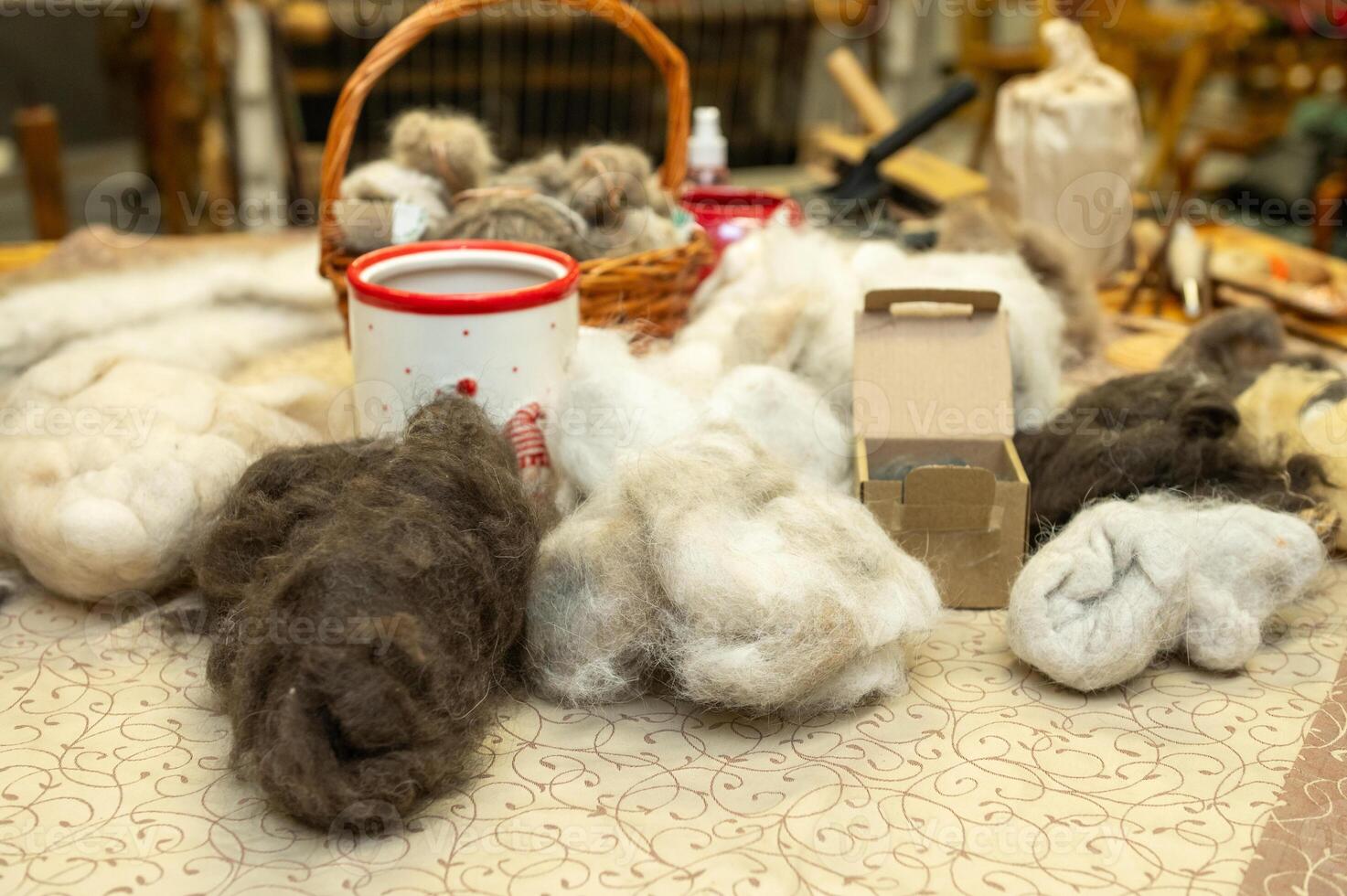 Wool fibers for crafting with basket, yarn, and natural materials on display photo