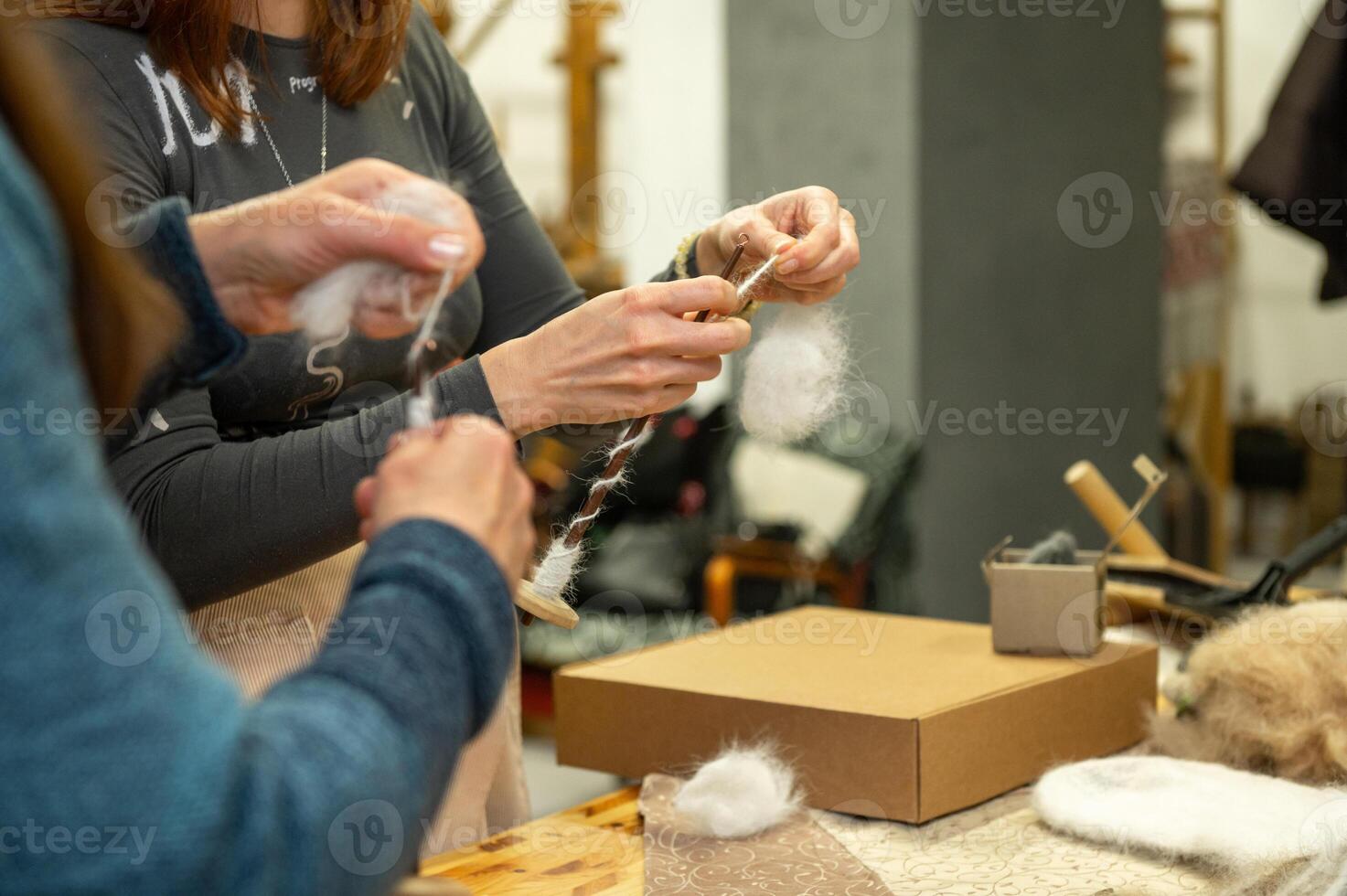 Adults engaged in wool crafting workshop photo