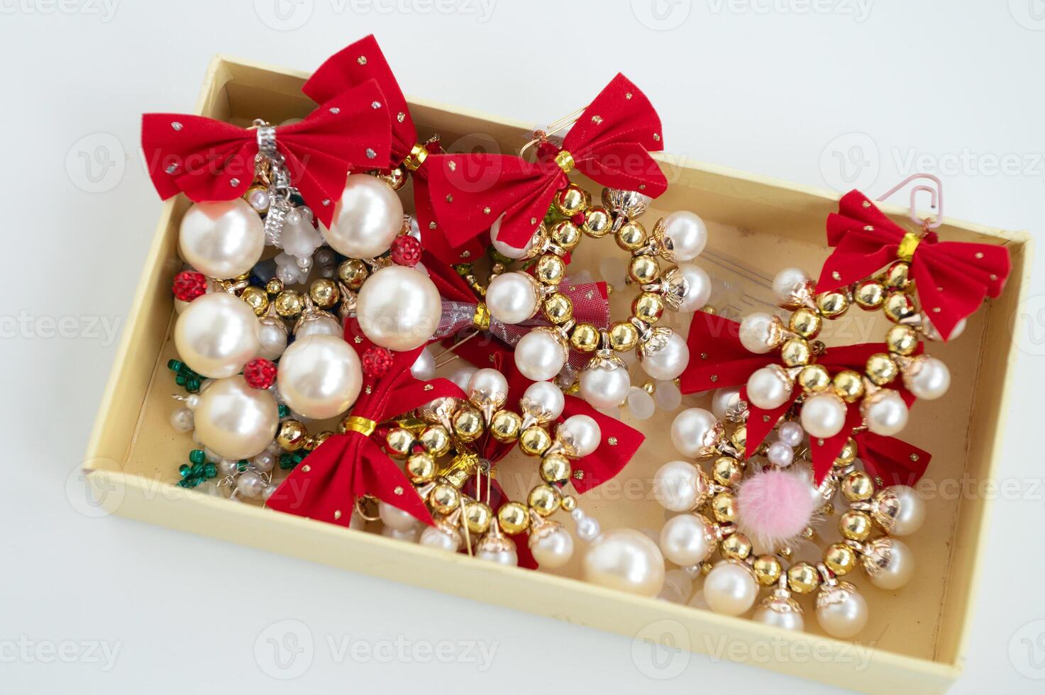 Elegant christmas ornaments with red bows and gold beads in a box photo