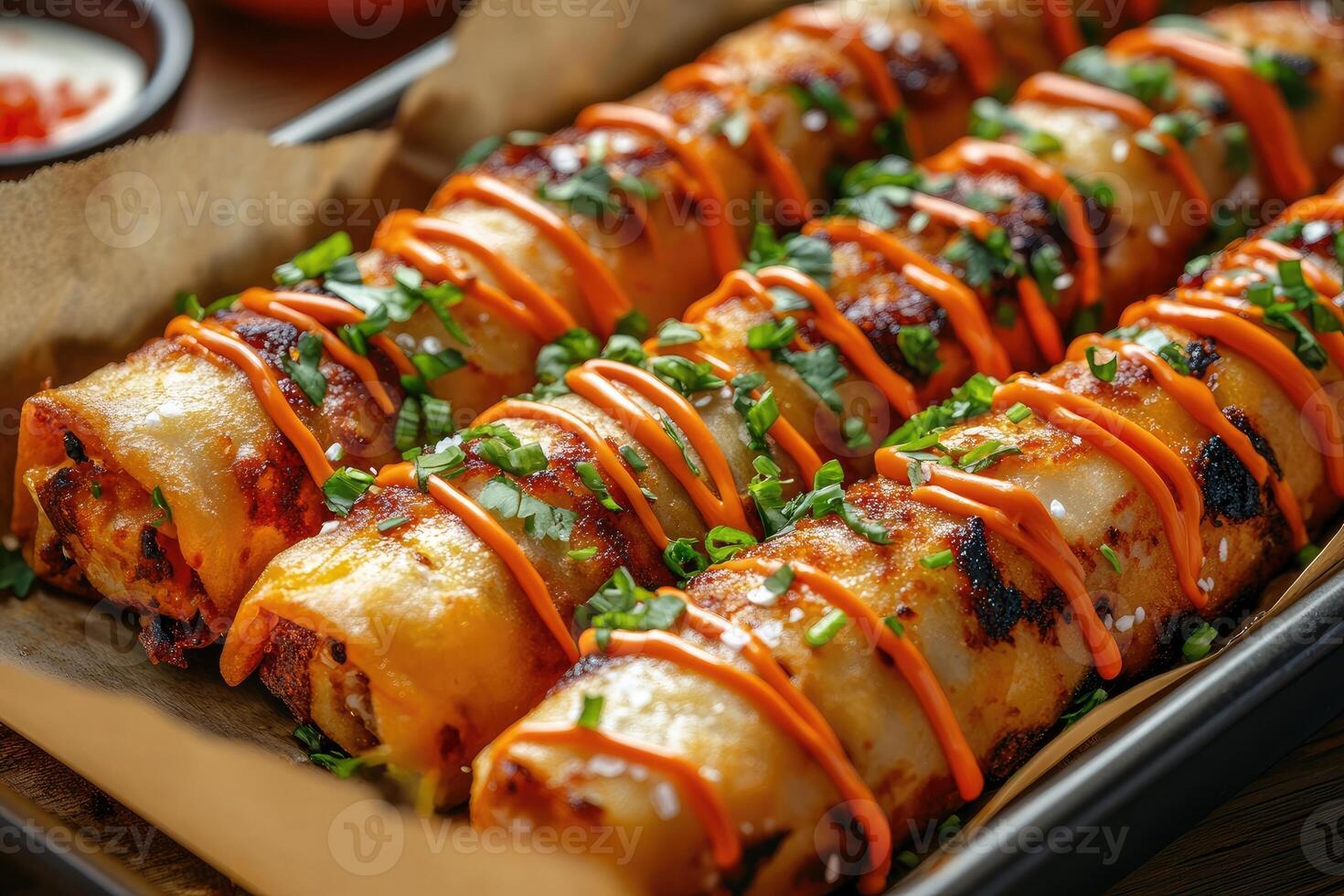 Delicious quesadillas with cilantro and spicy mayo drizzled on top, resting on baking paper photo