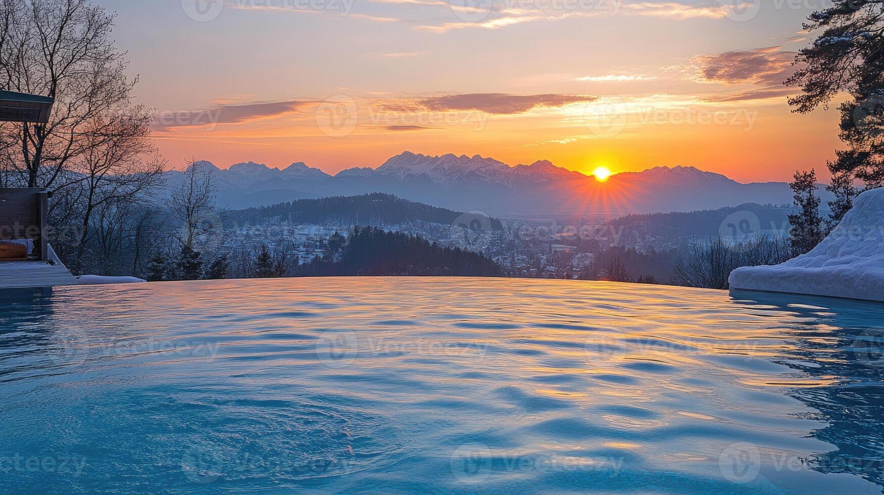 Infinity pool reflecting stunning sunset over bavarian alps in winter photo