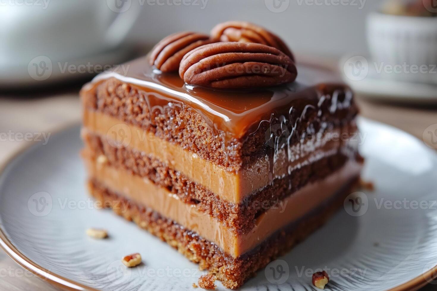 Delicious chocolate cake slice with caramel topping and pecan nuts photo