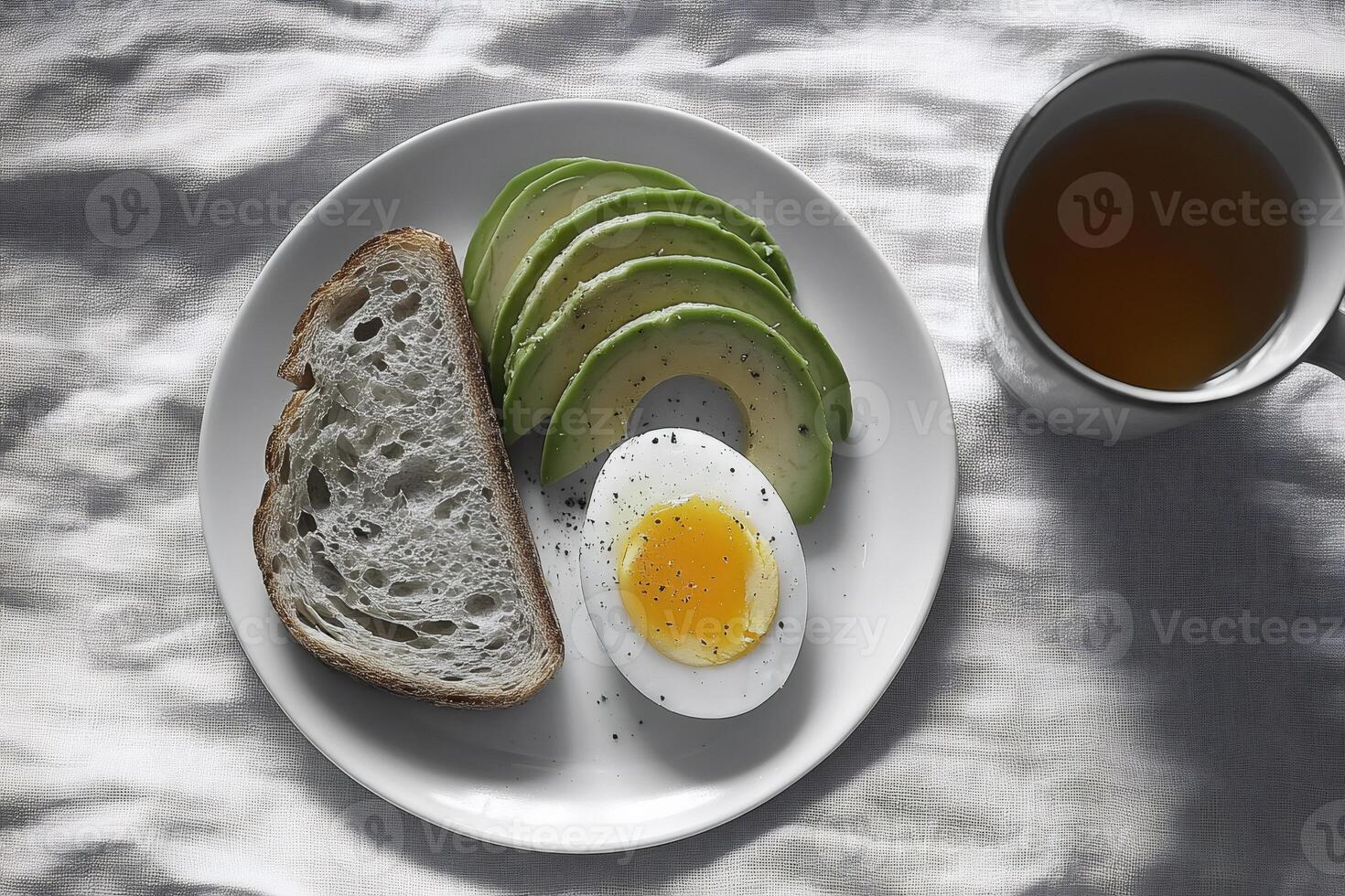 Healthy breakfast with avocado, boiled egg and toast on white plate photo