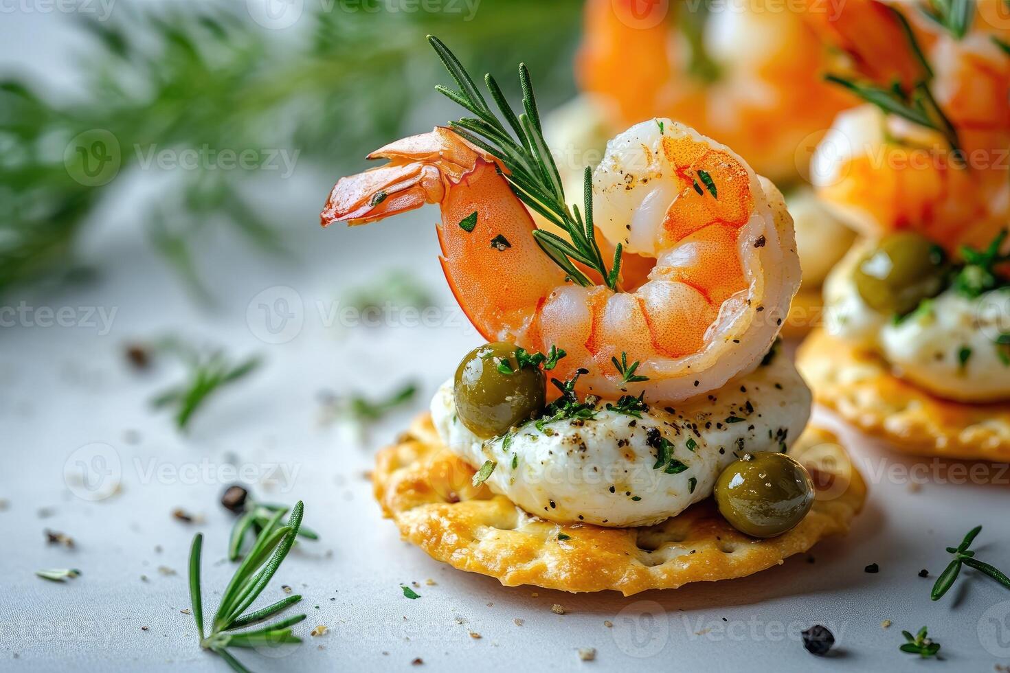 Delicious shrimp appetizer with cream cheese, capers, and rosemary on cracker photo
