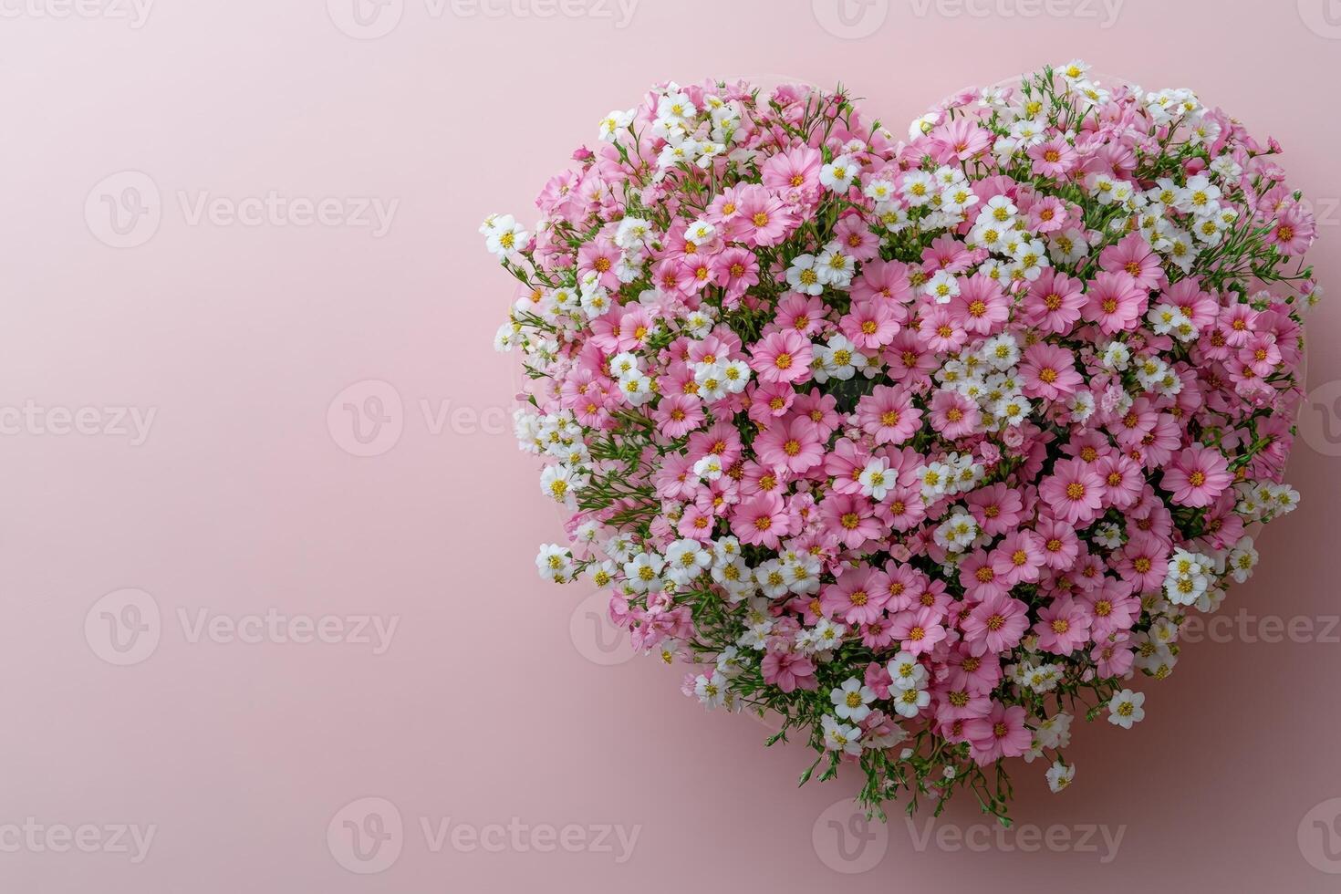 Heart shaped bouquet of pink and white cutter flowers on pink background photo