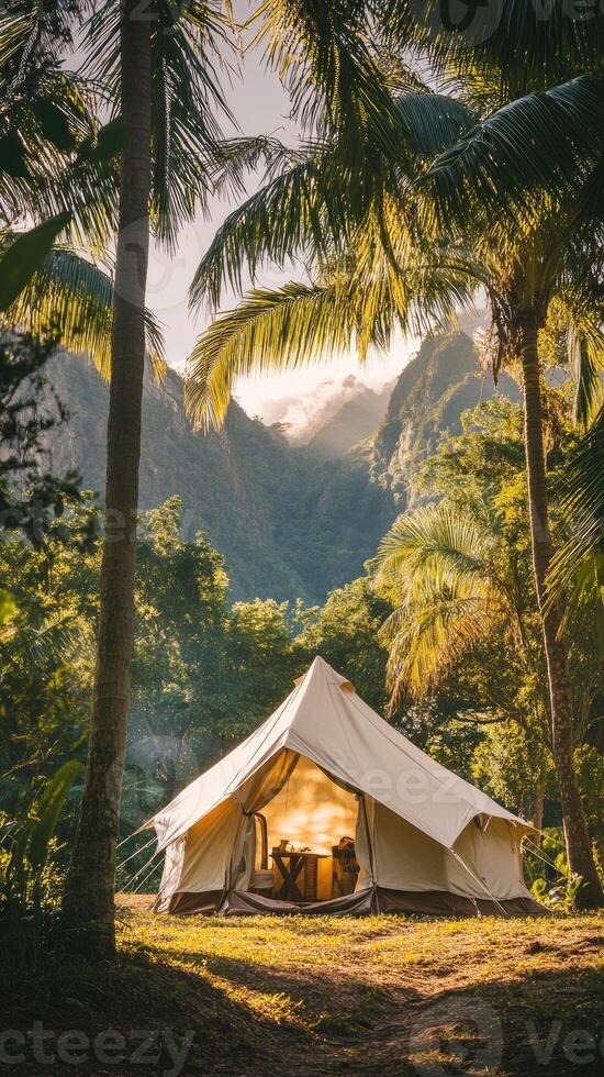 Tent camping under palm trees with mountain view in tropical paradise photo