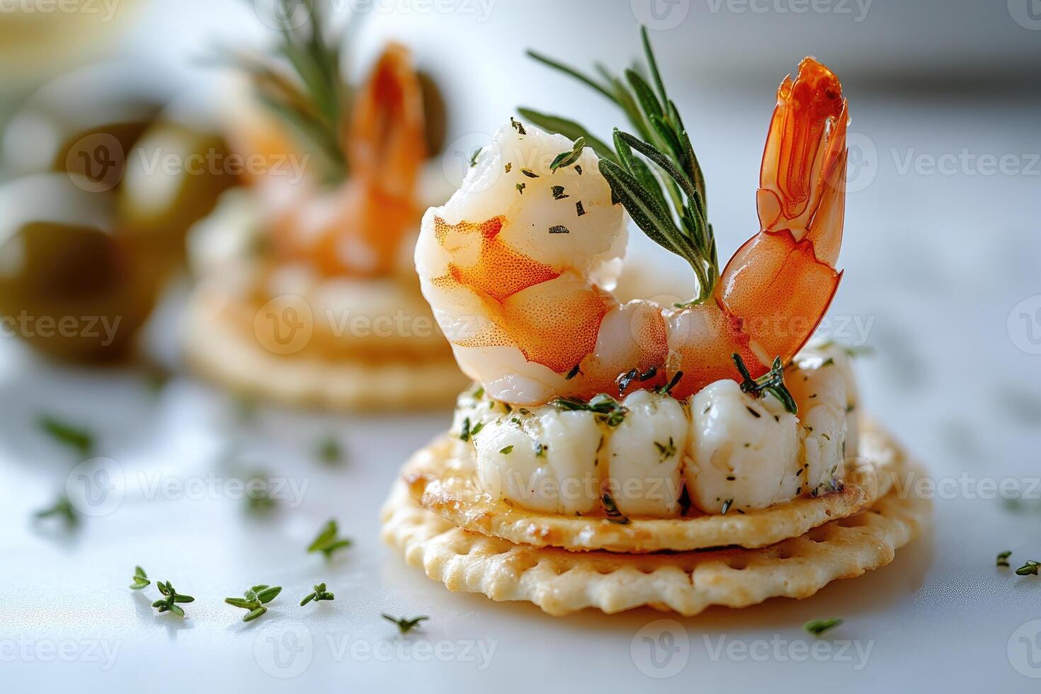 Delicious shrimp appetizer with cream cheese, capers, and rosemary on cracker photo