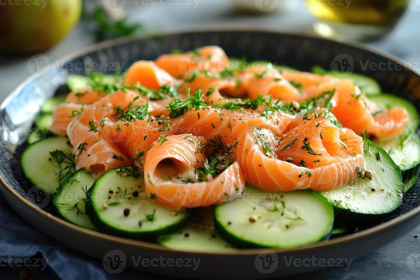 Delicious salmon with slices of cucumber, dill and peppercorns on a plate photo