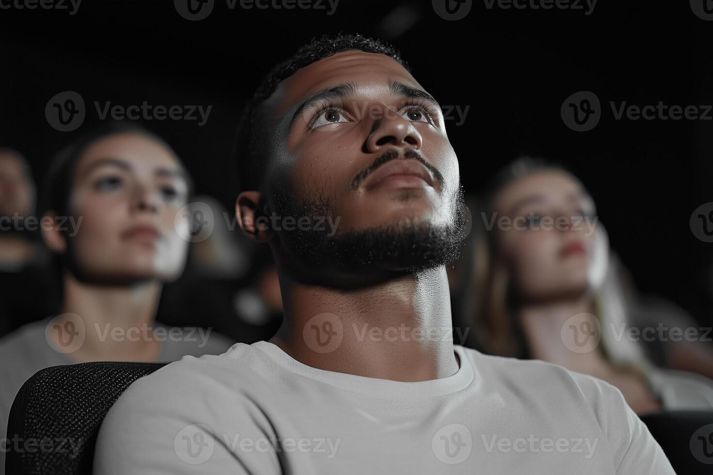 young african american man watching movie in cinema photo