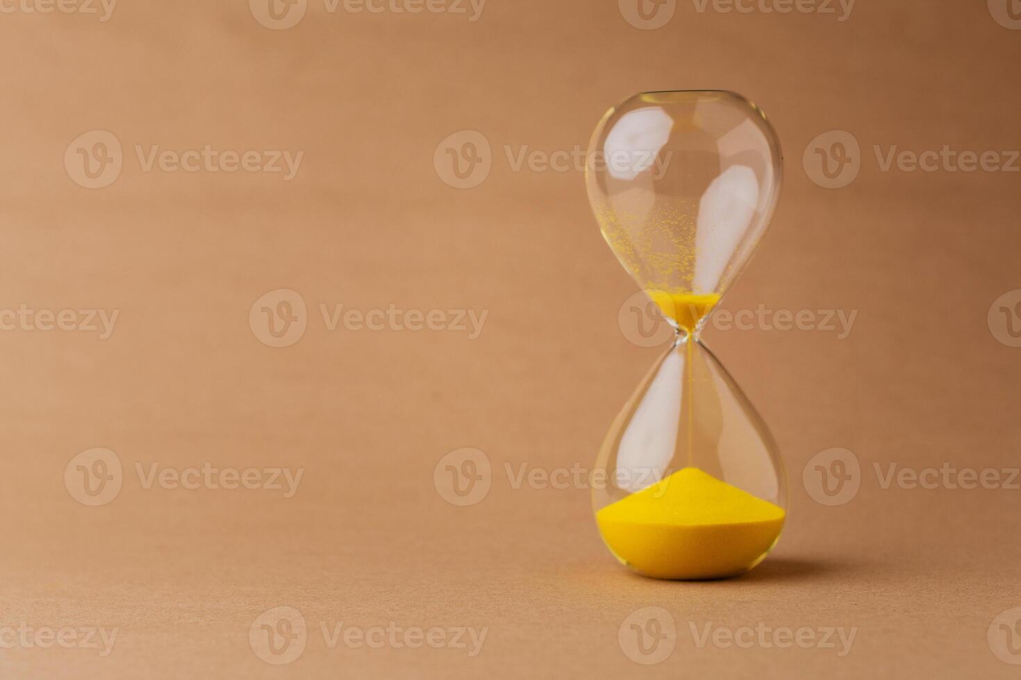 Hourglass, a timepiece, the rules of time and the rush of work, the value and meaning of time photo