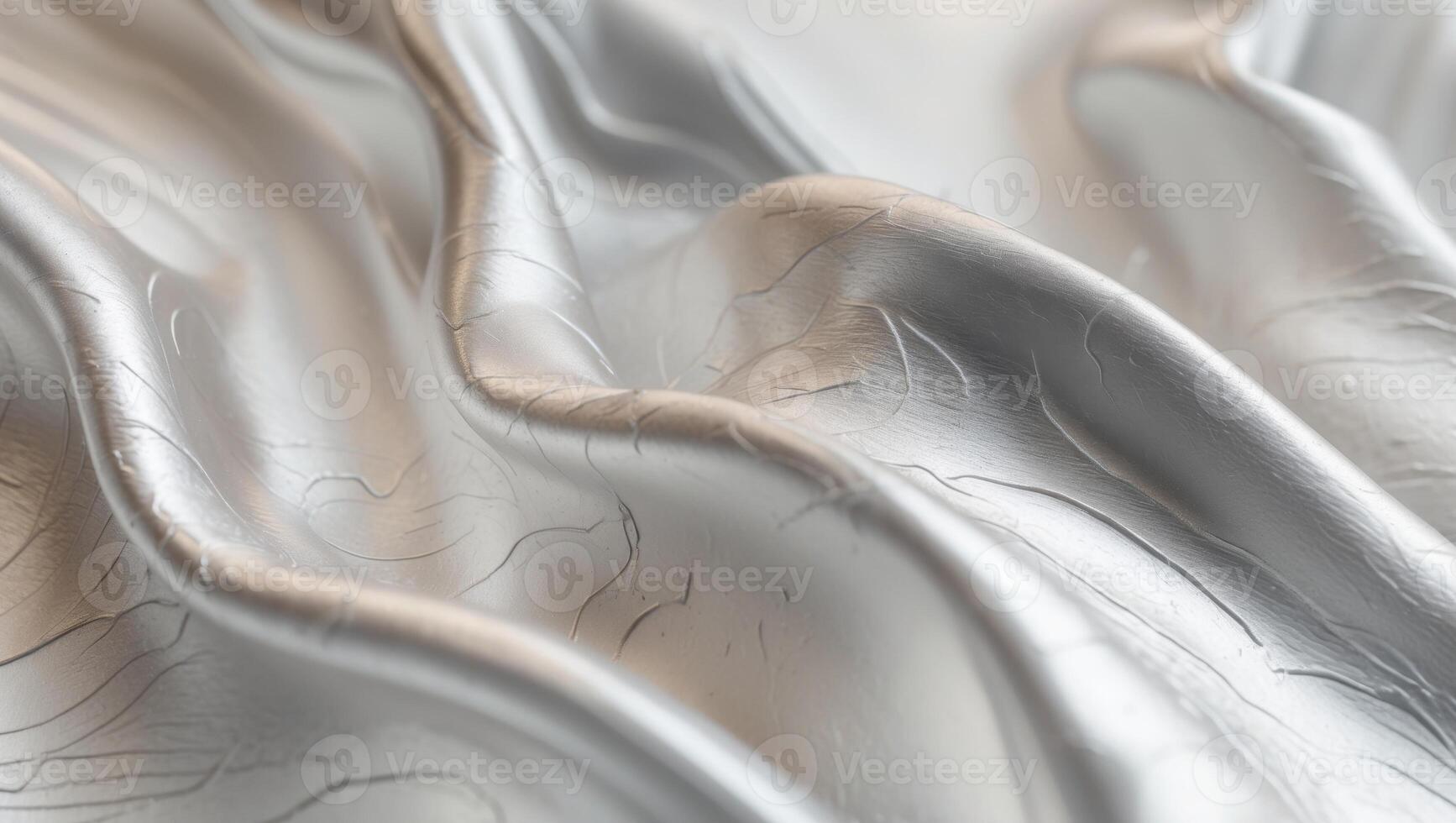 A close up of a silver fabric with a lot of folds photo
