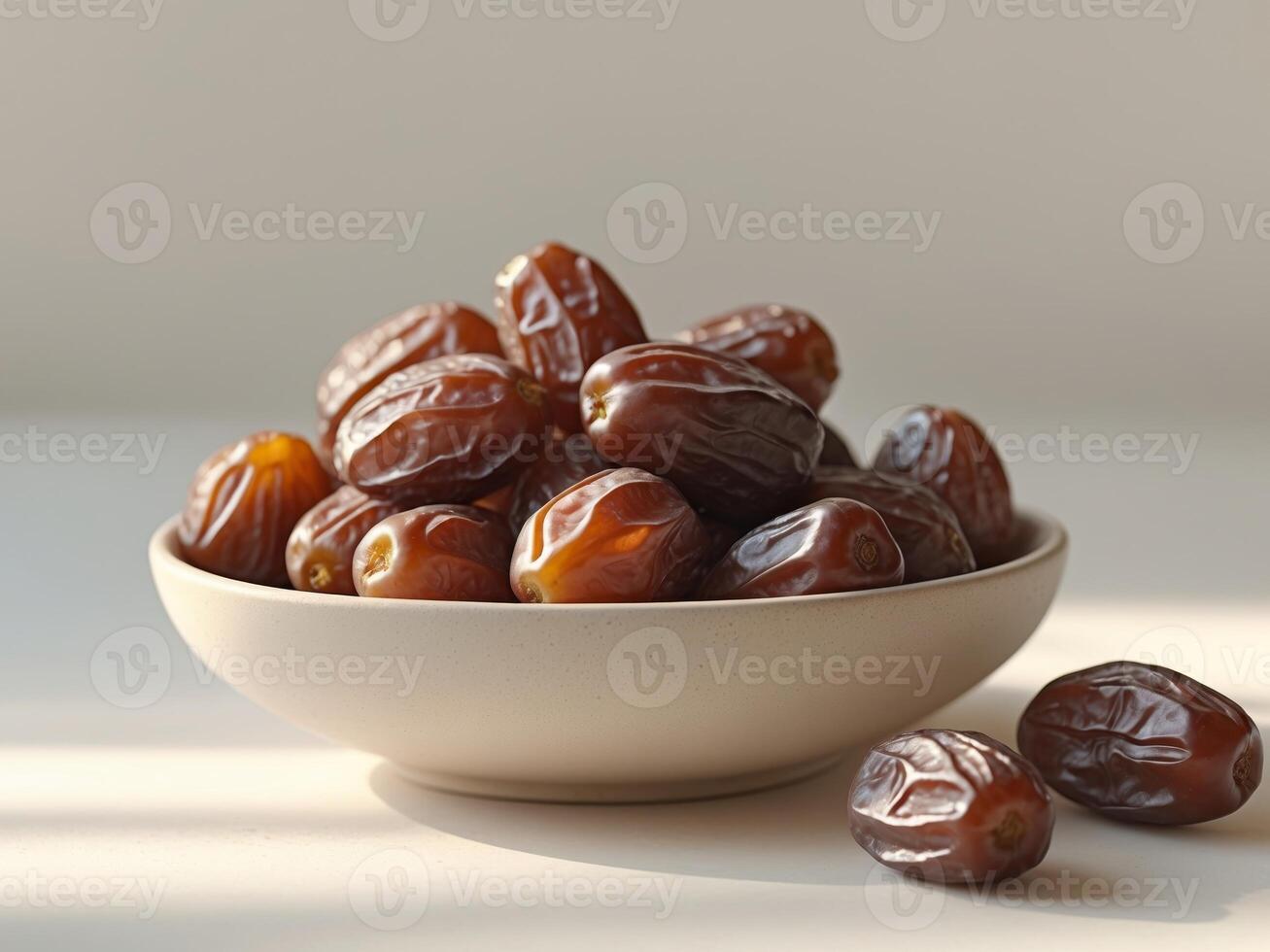 A bowl of dates on a table photo