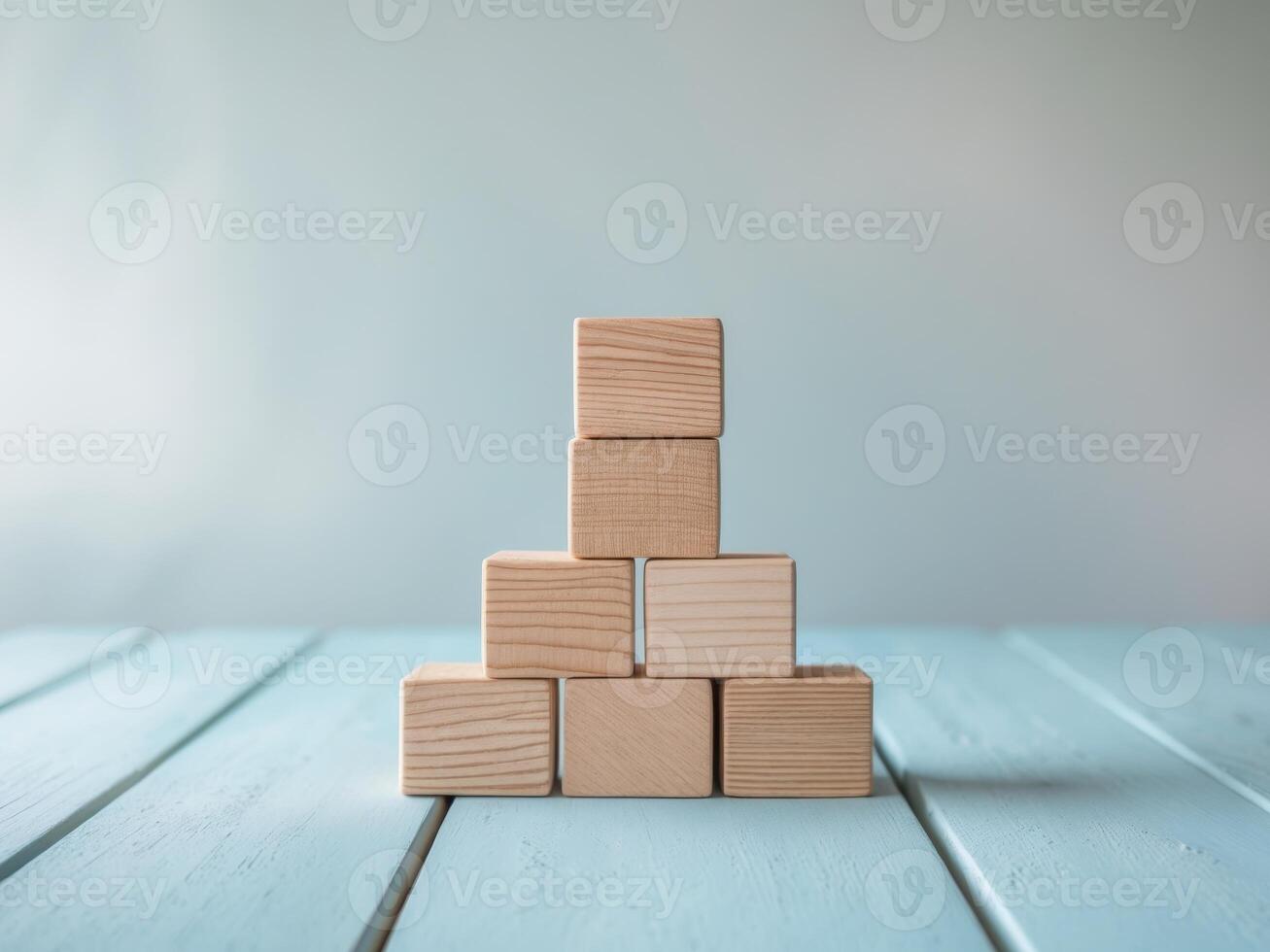 A stack of wooden blocks on a blue table photo