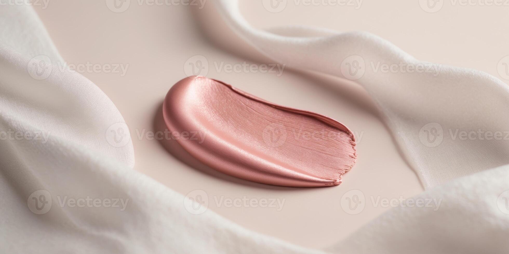 A pink lipstick on a white cloth photo