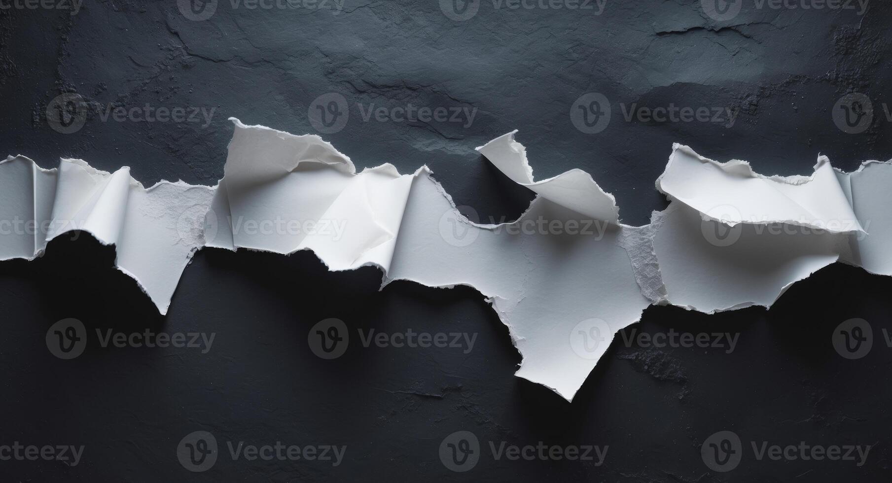 Torn paper on black wall photo