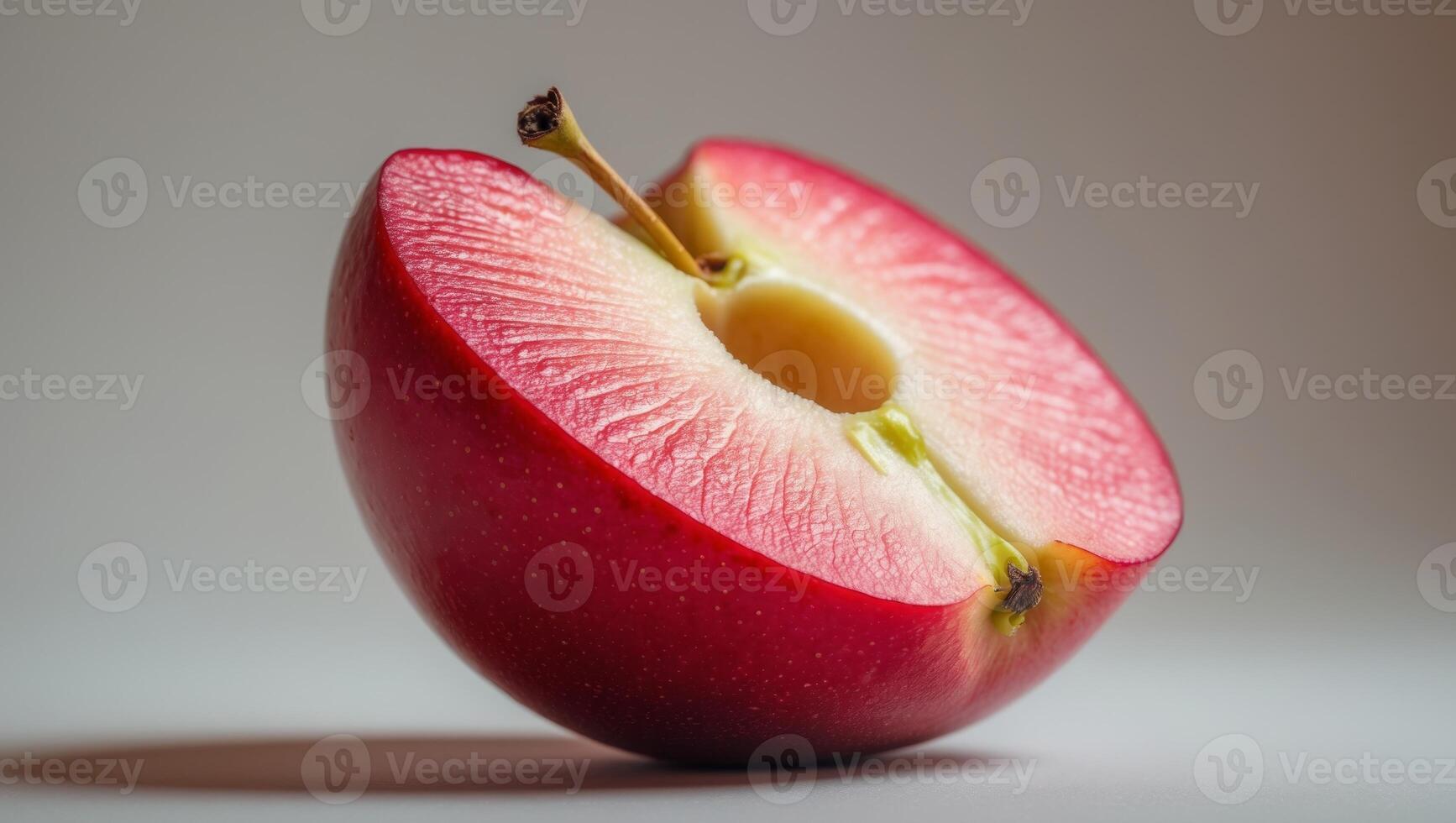 Juicy red apple slice with a smooth texture. photo