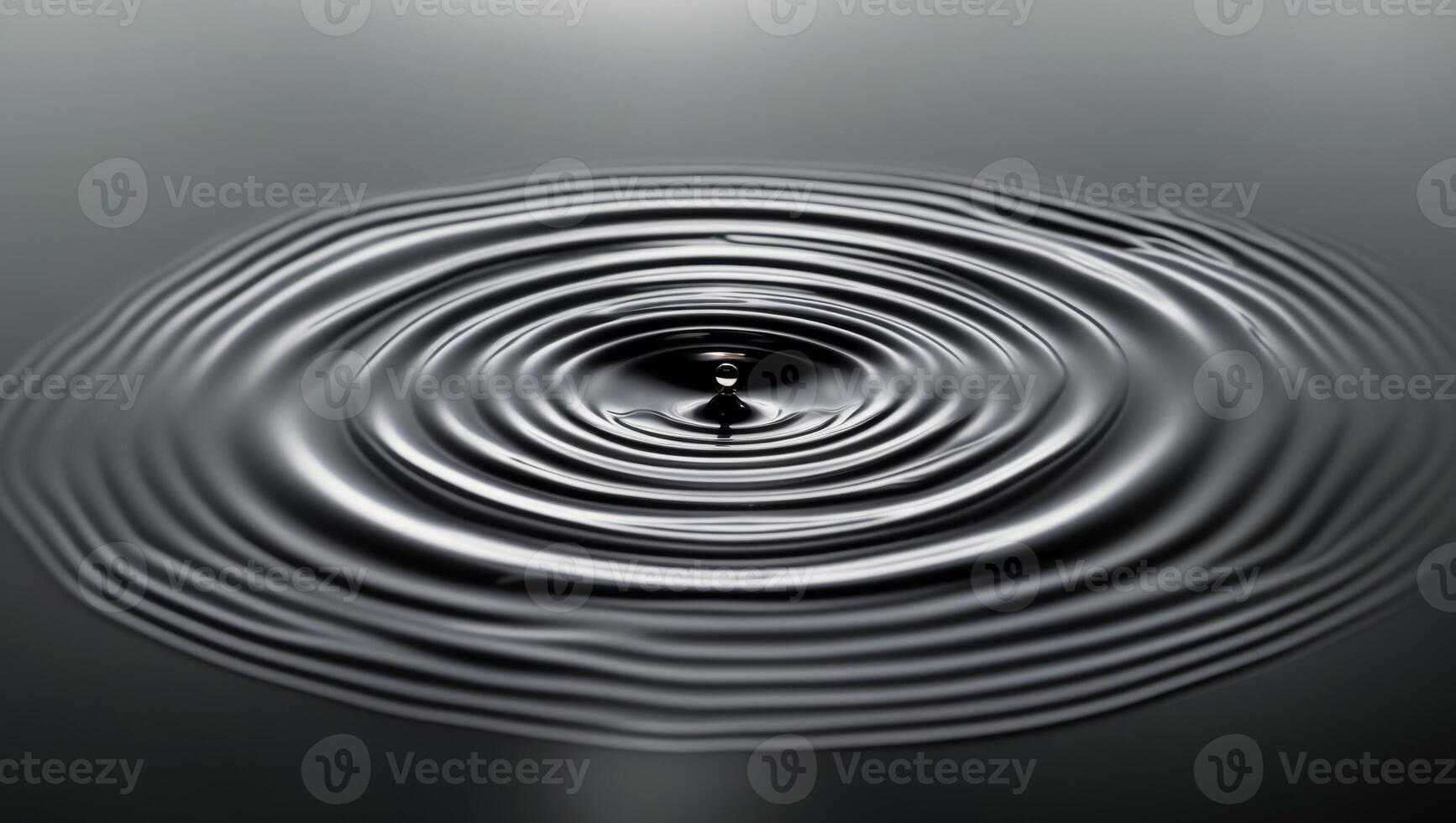 A circular drop of water is shown in the middle of a circle photo
