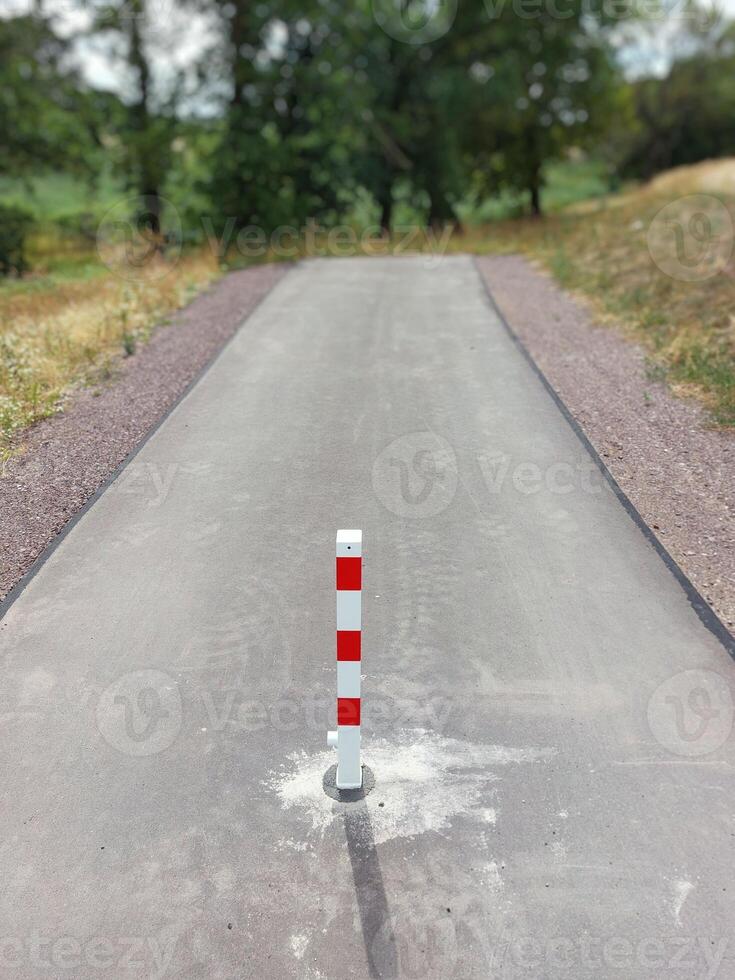 End of a small road with a red and white bollard in Germany photo