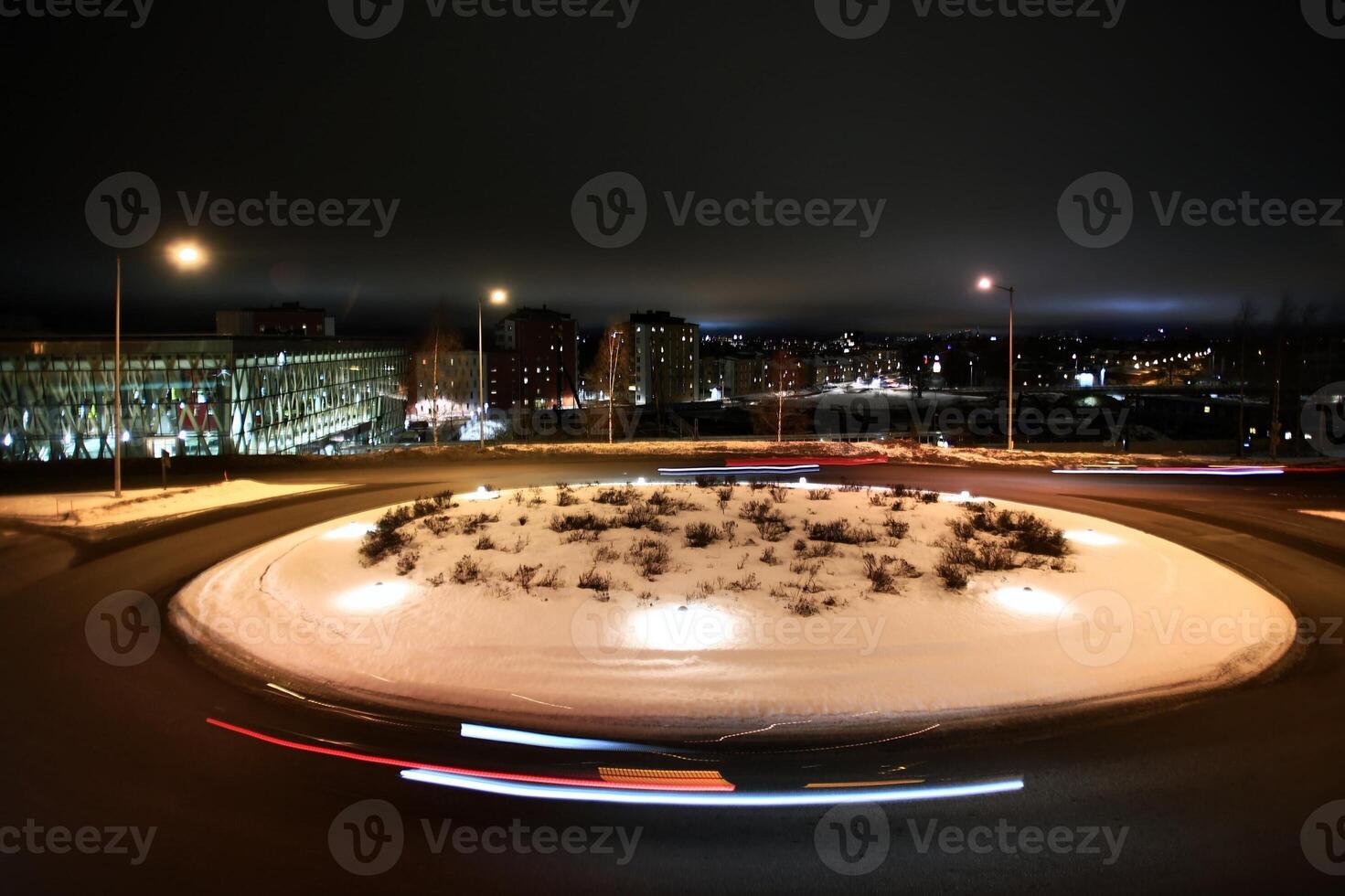 Long exposure shot of traffic circle in the winterly city of Umea in Sweden photo