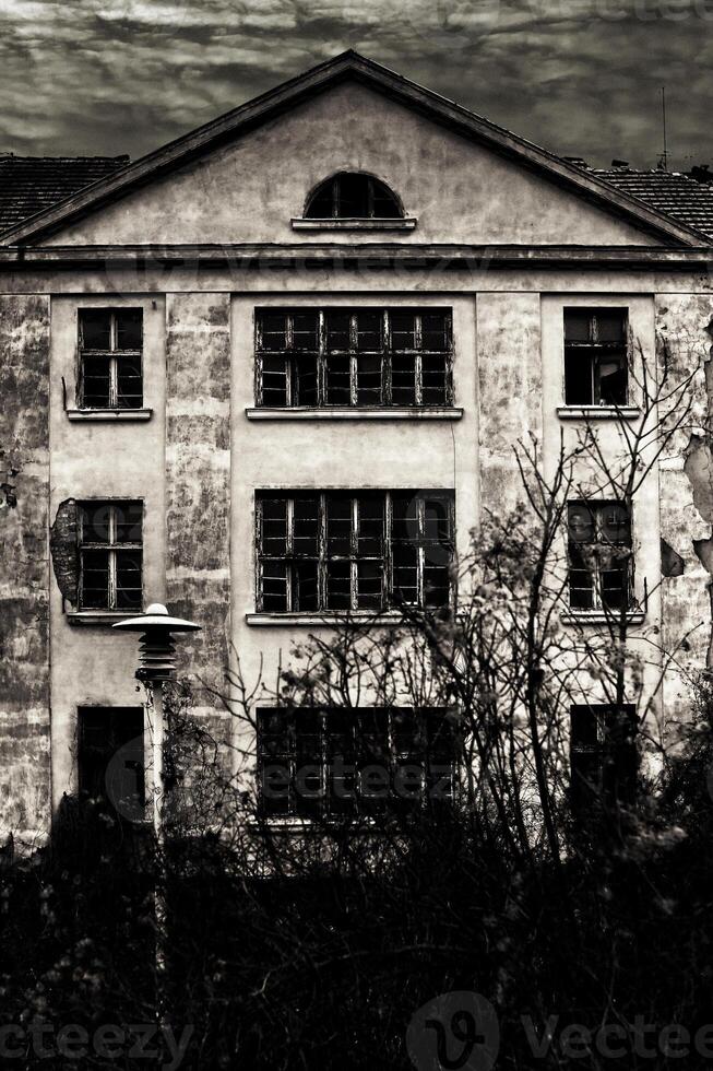 Black and white shot of haunted villa and cloudy sky photo