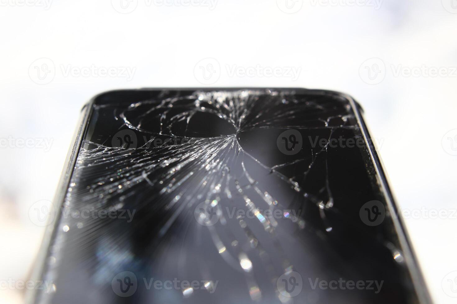 Macro of phone with broken display with white background photo