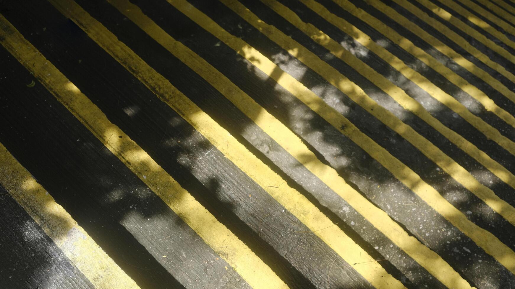 Sunlight and shadow on outdoor starcases with yellow lines photo