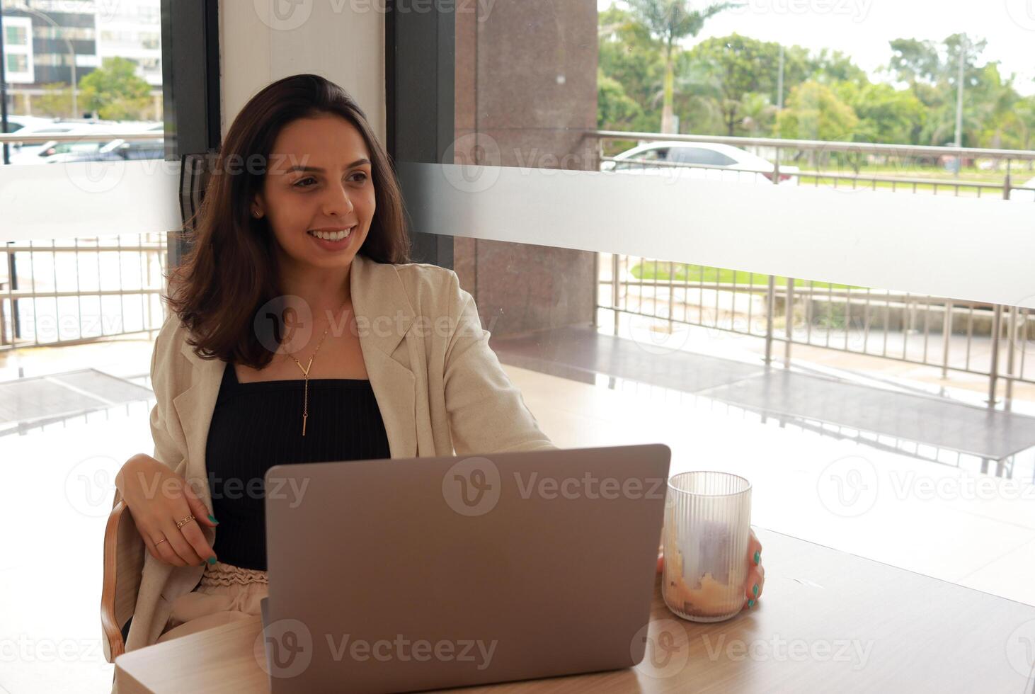 Portrait of a young Professional Businesswoman working on her Laptop in a coffee shop. Business concept photo