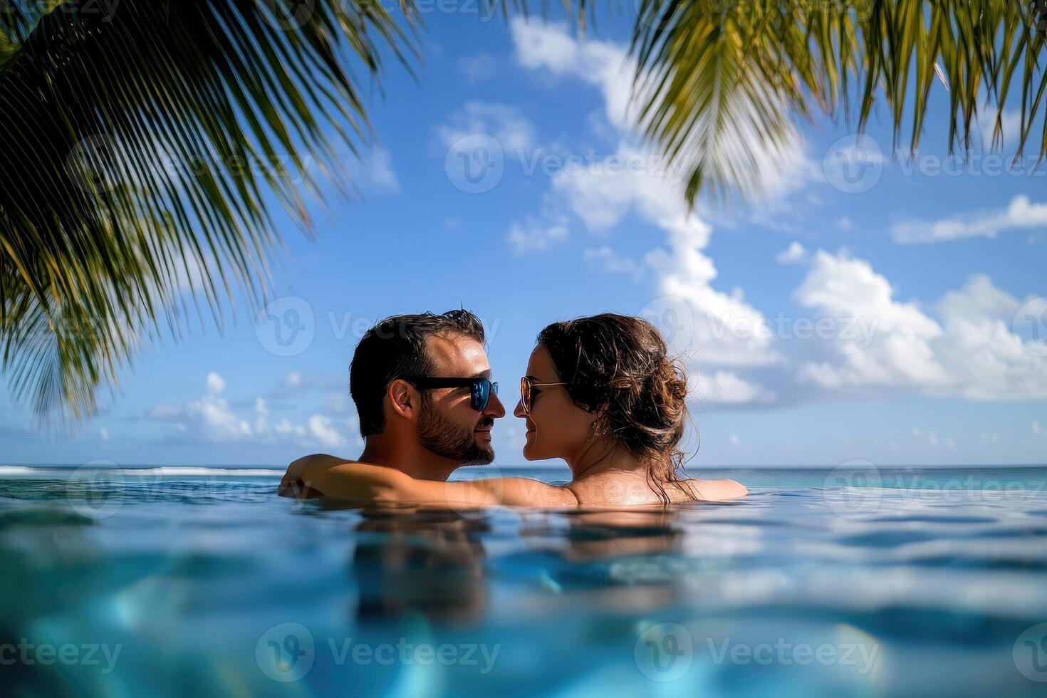 Couple enjoying beach vacation holidays at tropical resort with swimming pool and coconut palm trees near the coast with beautiful landscape. photo